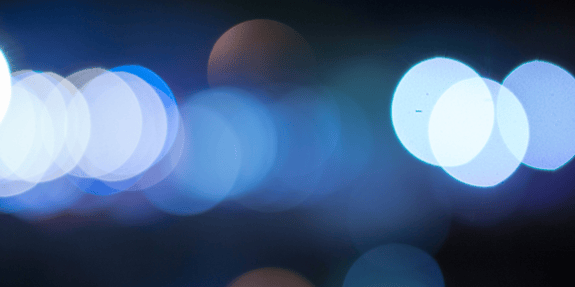 Blue specks of light on a dark background