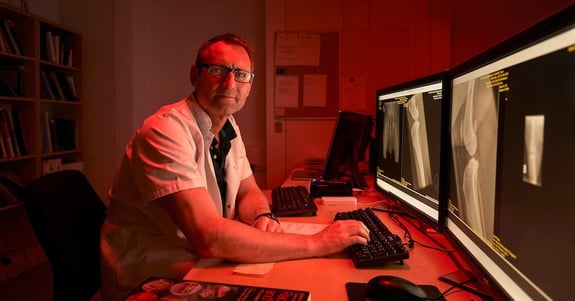 Ulrik Westrup, senior veterinarian, observes x-ray images on a screen in ergonomic lighting from Chromaviso
