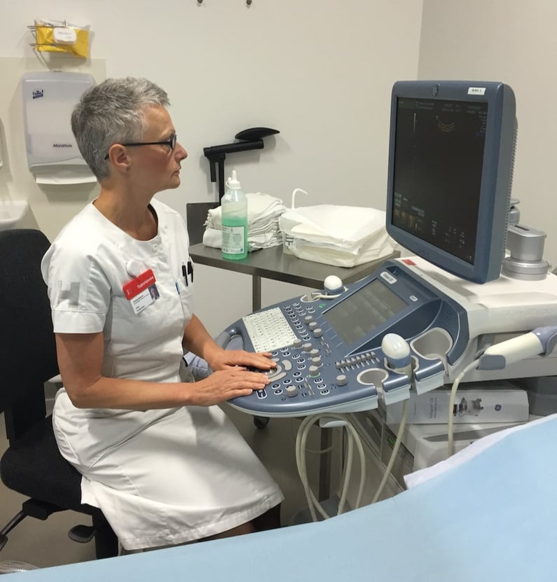 Nurse sits and observes scan images