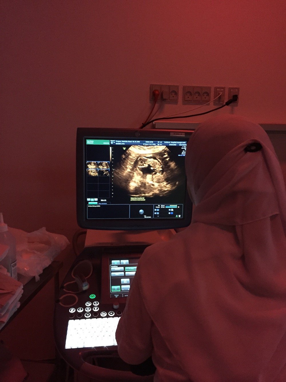 Midwife performs scan in violet light