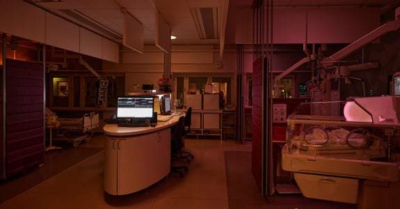 Neonatal ICU with an incubator and circadian lighting dividing the room into light zones