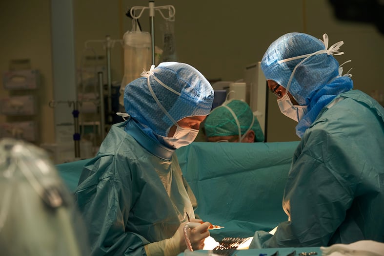 Surgeons operating in the hybrid room